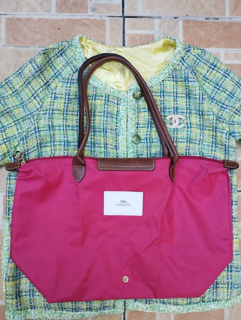 Longchamp Le Pliage Long Handle Tote Bag Pink (Category: Luxury Bags & Wallets) located in Manila. Submitted by beckster_nnline_luxuryshop (Listing ID 1467911751, Image 3). Description: Bright pink Longchamp nylon tote with brown leather handles and flap. Zip top closure with snap button detail. Classic everyday shoulder bag size. Measurements shown in pictures with tape measure. Clean fabric exterior and structured base. Great daily commuter or 