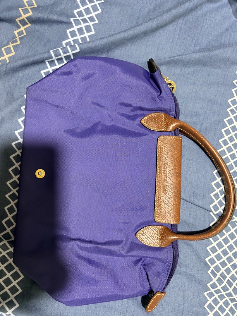 Longchamp Le Pliage Purple Handbag Small Short Handle (Category: Luxury Bags & Wallets) located in Quezon City. Submitted by pattycloset08 (Listing ID 1467965856, Image 2). Description: - Authentic Longchamp Le Pliage Handbag (Size S) - Color: Purple with signature brown leather trim - Hardware: Gold-tone - Closure: Zip top with snap button flap - Features: Short handles, lightweight foldable nylon fabric - Condition: Well-maintained with clean c