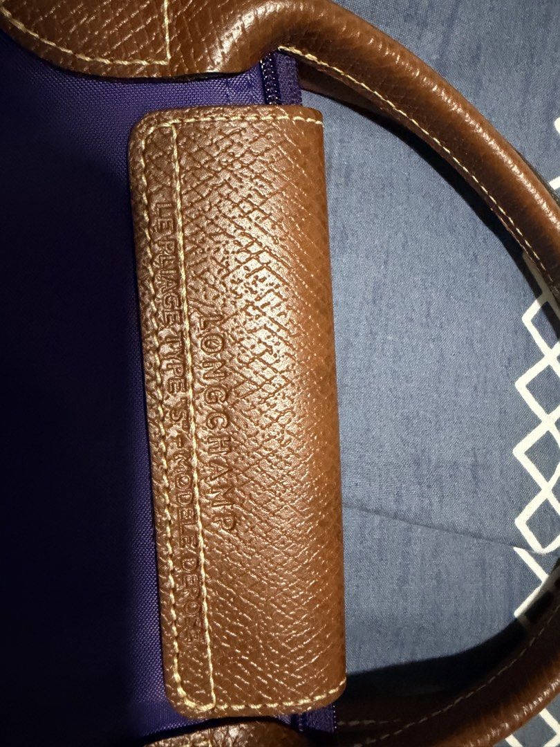 Longchamp Le Pliage Purple Handbag Small Short Handle (Category: Luxury Bags & Wallets) located in Quezon City. Submitted by pattycloset08 (Listing ID 1467965856, Image 3). Description: - Authentic Longchamp Le Pliage Handbag (Size S) - Color: Purple with signature brown leather trim - Hardware: Gold-tone - Closure: Zip top with snap button flap - Features: Short handles, lightweight foldable nylon fabric - Condition: Well-maintained with clean c