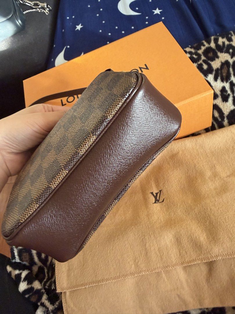 Louis Vuitton Damier Ebene Pochette Accessoires (Category: Luxury Bags & Wallets) located in Manila. Submitted by arcietan02437 (Listing ID 1467919676, Image 2). Description: - Authentic Louis Vuitton Damier Ebene Pochette - Iconic brown checkerboard pattern with leather trim and gold-tone hardware - Secure top zipper closure - Includes matching leather strap - Comes complete with orange Louis Vuitton box and dust bag - Well-maintained with a ver
