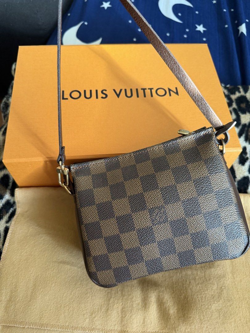 Louis Vuitton Damier Ebene Pochette Accessoires (Category: Luxury Bags & Wallets) located in Manila. Submitted by arcietan02437 (Listing ID 1467919676, Image 1). Description: - Authentic Louis Vuitton Damier Ebene Pochette - Iconic brown checkerboard pattern with leather trim and gold-tone hardware - Secure top zipper closure - Includes matching leather strap - Comes complete with orange Louis Vuitton box and dust bag - Well-maintained with a ver