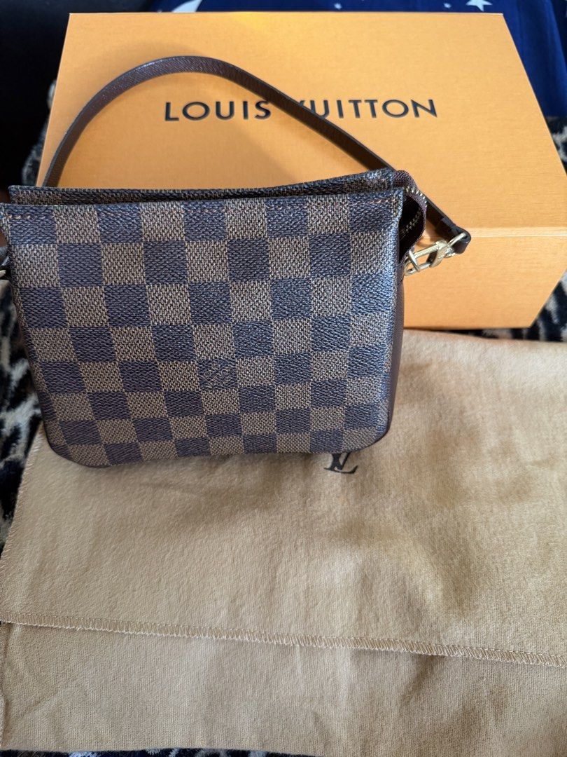 Louis Vuitton Damier Ebene Pochette Accessoires (Category: Luxury Bags & Wallets) located in Manila. Submitted by arcietan02437 (Listing ID 1467919676, Image 3). Description: - Authentic Louis Vuitton Damier Ebene Pochette - Iconic brown checkerboard pattern with leather trim and gold-tone hardware - Secure top zipper closure - Includes matching leather strap - Comes complete with orange Louis Vuitton box and dust bag - Well-maintained with a ver