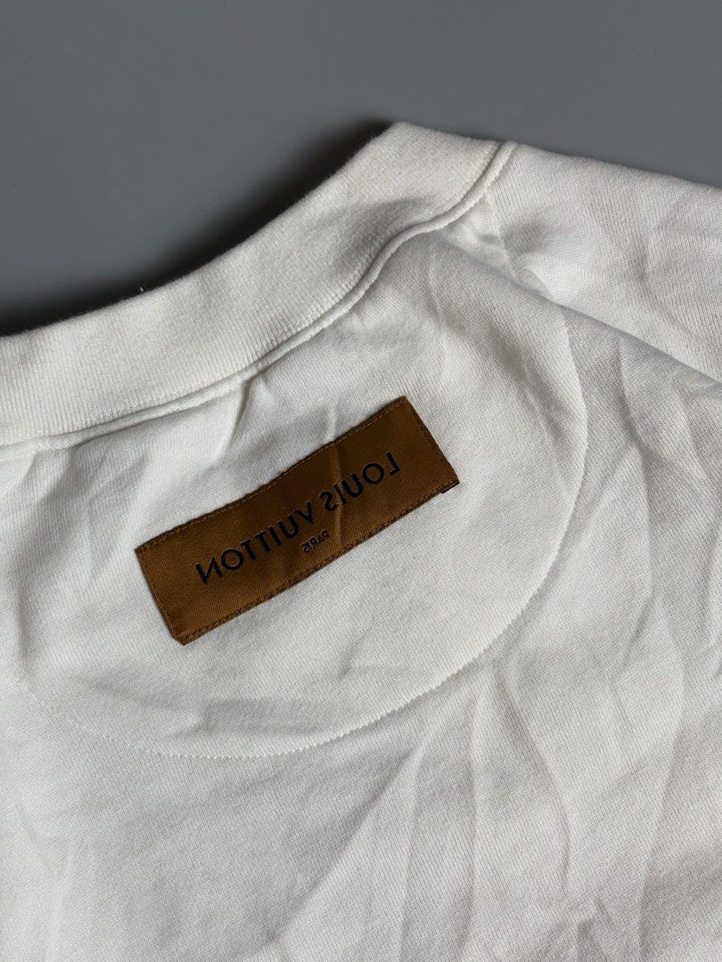 Louis Vuitton White Sweatshirt XL (Category: Coats, Jackets and Outerwear) located in Manila. Submitted by livefalcon-c64e (Listing ID 1467944300, Image 3). Description: - Brand: Louis Vuitton - Item: Crewneck Sweatshirt - Size: XL - Color: White - Material: Soft cotton fleece (Made in Italy) - Design: Classic crewneck with stitched V-insert, interior neck label, and outer back brown label detail - Features: Long sleeves with ribbed cuffs and hem