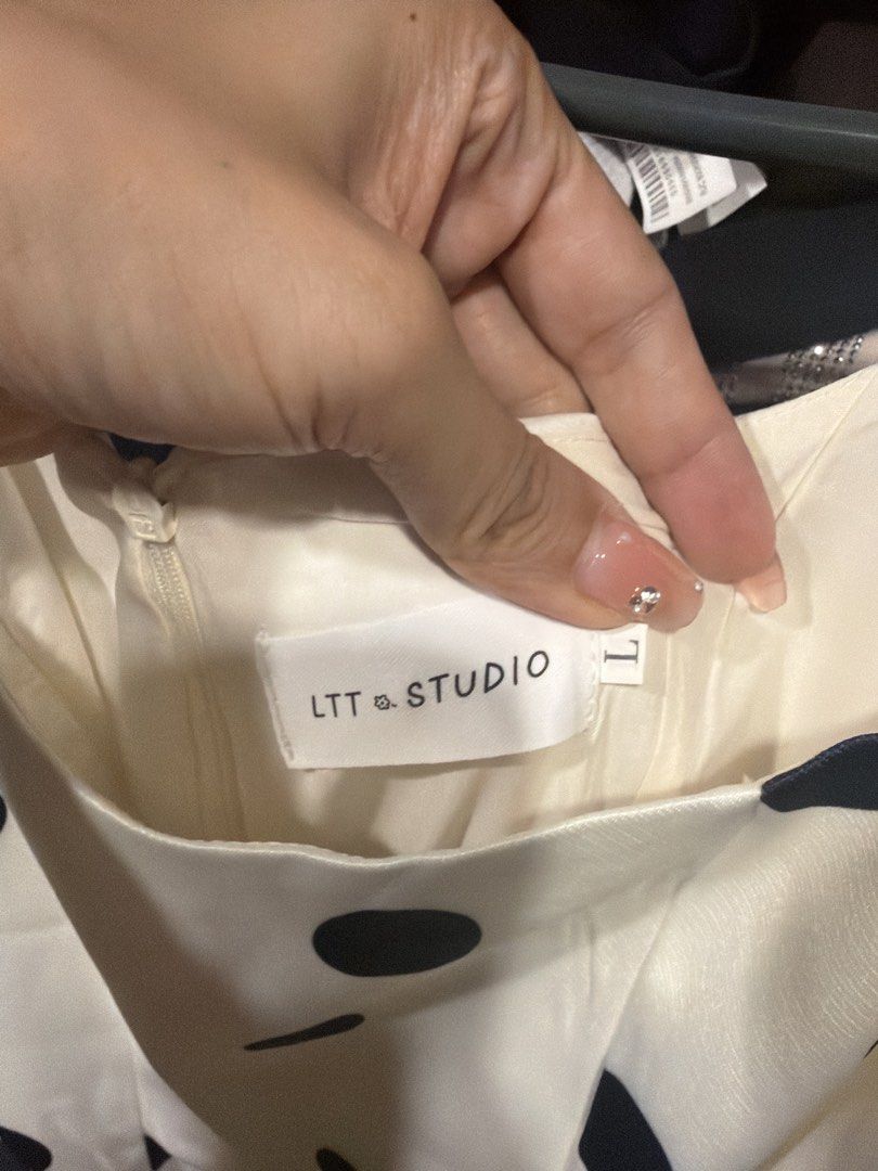LTT Studio White Polka Dot Midi Dress Size L (Category: Dresses) located in Quezon City. Submitted by branded_closet01 (Listing ID 1467965788, Image 3). Description: White midi dress covered in black polka dots. Thick satin-like fabric with structured hip details and square neckline. Sleeveless style with back zipper closure. Brand tag shows LTT Studio, size L. Can fit M. Very good quality like apartment 8..