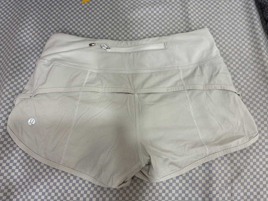 Lululemon Speed Up Shorts White (Category: Shorts) located in Manila. Submitted by shopmyclothesguys (Listing ID 1467922899, Image 3). Description: - Brand: Lululemon - Color: White - Style: Lightweight running shorts with inner lining - Features: High-rise waistband, secure back zip pocket, reflective logo on back hem - Condition: Good, but has small ink stains near the front seam (clearly shown in the 2nd photo) - Perfect for your daily runs an