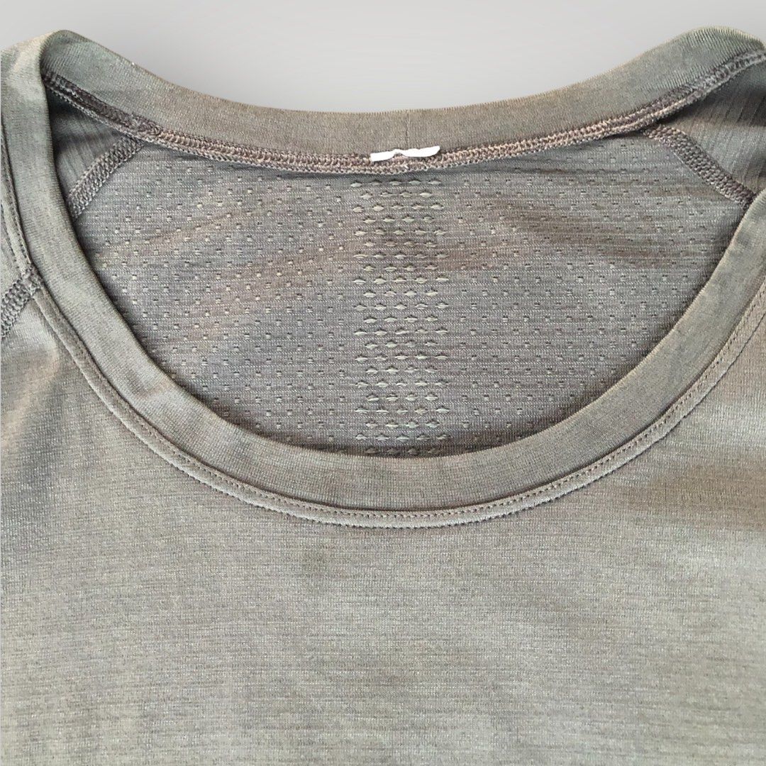 Lululemon Swiftly Tech Short Sleeve Crew (Category: Shirts) located in Paranaque City. Submitted by lesstash001 (Listing ID 1467978135, Image 3). Description: - Brand: Lululemon - Color: Greyish green - Design: Seamless construction with targeted mesh ventilation at the chest and upper back - Features: Classic crew neckline, short sleeves, and reflective logo on the upper back - Material: Sweat-wicking performance fabric - Condition: Excellent / 