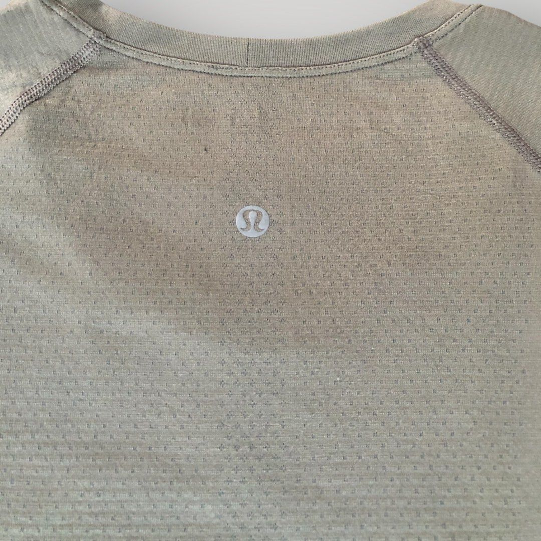 Lululemon Swiftly Tech Short Sleeve Crew (Category: Shirts) located in Paranaque City. Submitted by lesstash001 (Listing ID 1467978135, Image 2). Description: - Brand: Lululemon - Color: Greyish green - Design: Seamless construction with targeted mesh ventilation at the chest and upper back - Features: Classic crew neckline, short sleeves, and reflective logo on the upper back - Material: Sweat-wicking performance fabric - Condition: Excellent / 