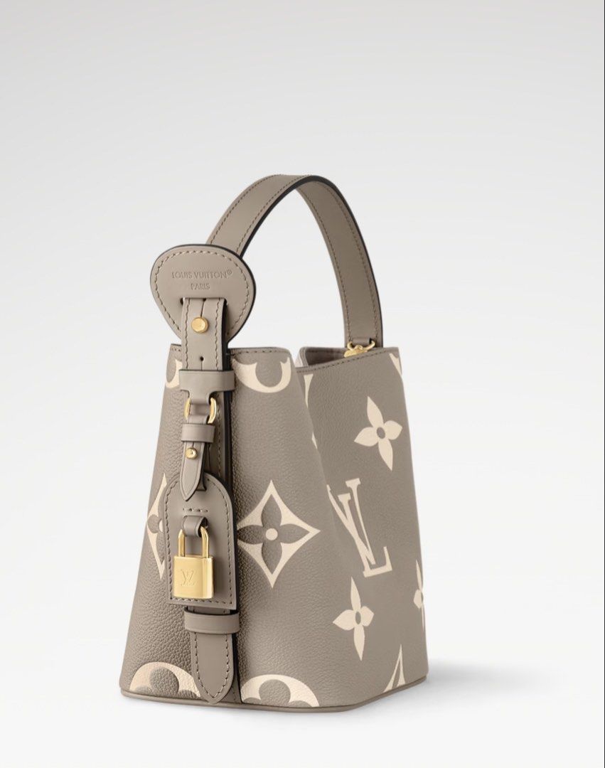 LV Nano Bucket Bag Monogram Empreinte (Category: Clutches) located in San Mateo. Submitted by trendsph_956 (Listing ID 1467840798, Image 2). Description: - Model: Nano Bucket Bag - Material: Monogram Empreinte leather in grey with cream embossed pattern - Hardware: Gold-tone throughout - Closure: Secure magnetic snap - Features: Structured shape, top handle, and cute padlock charm detail - Inclusion: Matching removable zipped pouch inside - Condi