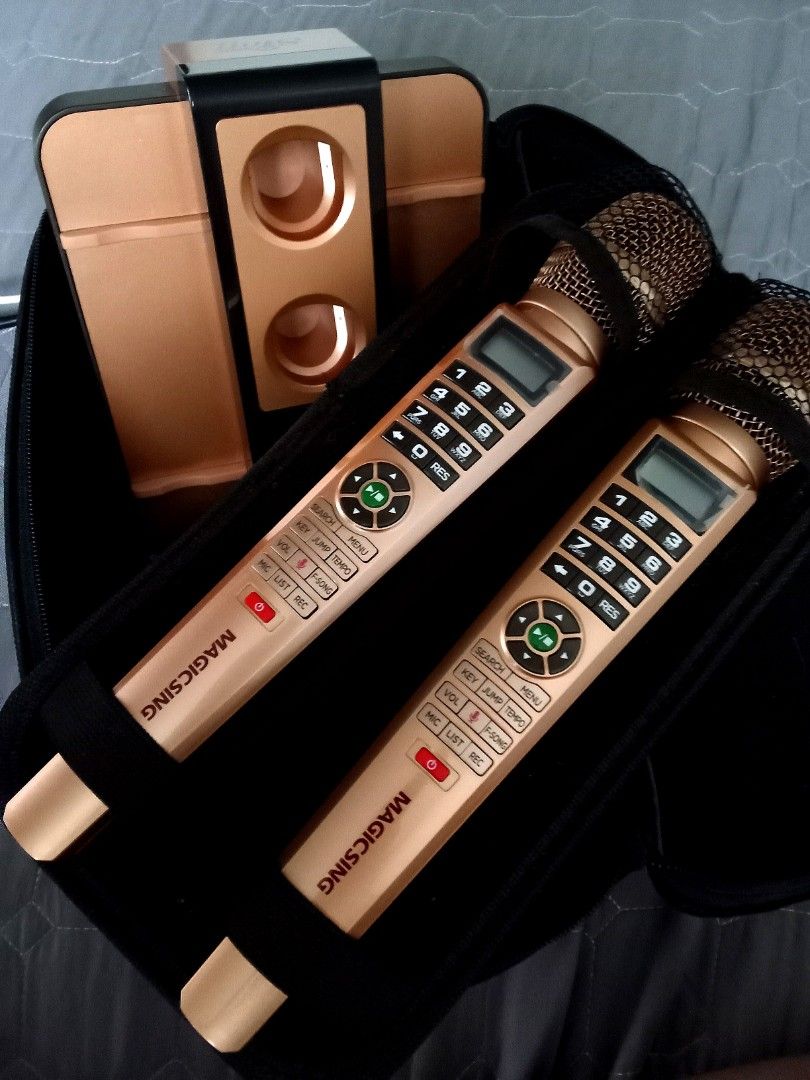 Magic Sing Karaoke System with Dual Microphones and Base (Category: Soundbars, Speakers & Amplifiers) located in Quezon City. Submitted by santos2016 (Listing ID 1467848119, Image 1). Description: - Complete Magic Sing karaoke set, perfect for home parties and family bonding - Includes 2 gold wireless microphones with built-in numeric keypads and LCD screens - Comes with a dual-slot charging base station, power adapters, and necessary cables - In