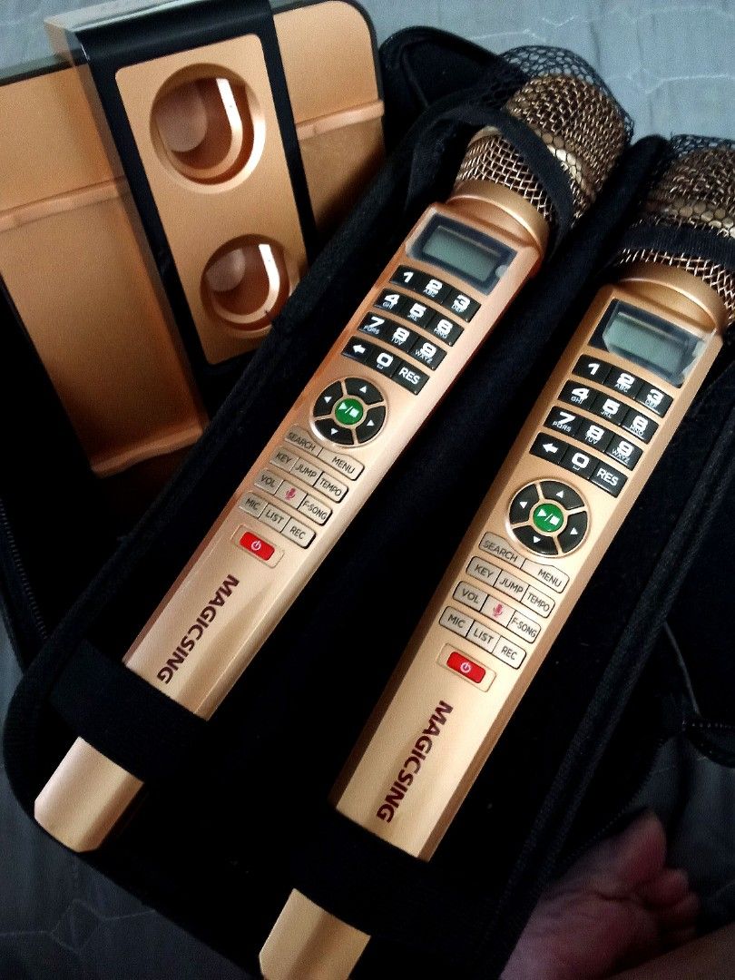 Magic Sing Karaoke System with Dual Microphones and Base (Category: Soundbars, Speakers & Amplifiers) located in Quezon City. Submitted by santos2016 (Listing ID 1467848119, Image 2). Description: - Complete Magic Sing karaoke set, perfect for home parties and family bonding - Includes 2 gold wireless microphones with built-in numeric keypads and LCD screens - Comes with a dual-slot charging base station, power adapters, and necessary cables - In