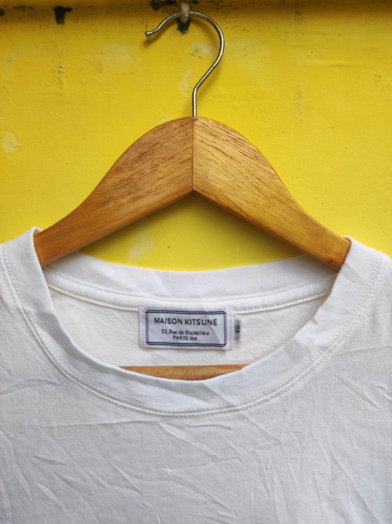 Maison Kitsuné White Fox Patch T-Shirt (Category: Shirts) located in Cuartero. Submitted by tripthriftfinds (Listing ID 1467879757, Image 3). Description: - Brand: Maison Kitsuné - Color: White - Size: XS - Material: 100% Cotton (Made in Portugal) - Design: Iconic sitting fox patch on chest, classic crew neck, short sleeves - Condition: Clean piece with solid collar and cuffs; has minor storage wrinkling and needs a quick iron.