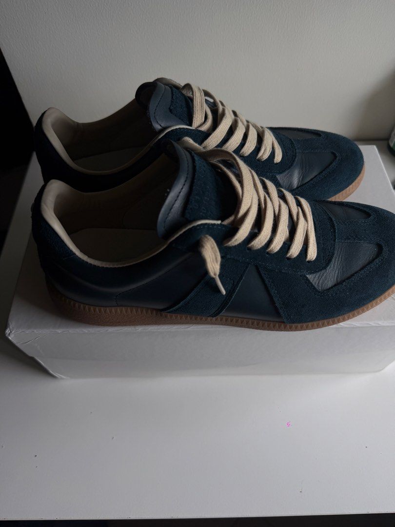 Maison Margiela Gats (Category: Casual Shoes) located in Manila. Submitted by decluttering6767 (Listing ID 1467889230, Image 1). Description: ₱7,000 (nego) - Brand: Maison Margiela - Model: Replica Sneakers - Color: Dark Navy Blue with cream laces - Materials: Premium leather and suede panels - Inclusions: Original white box .