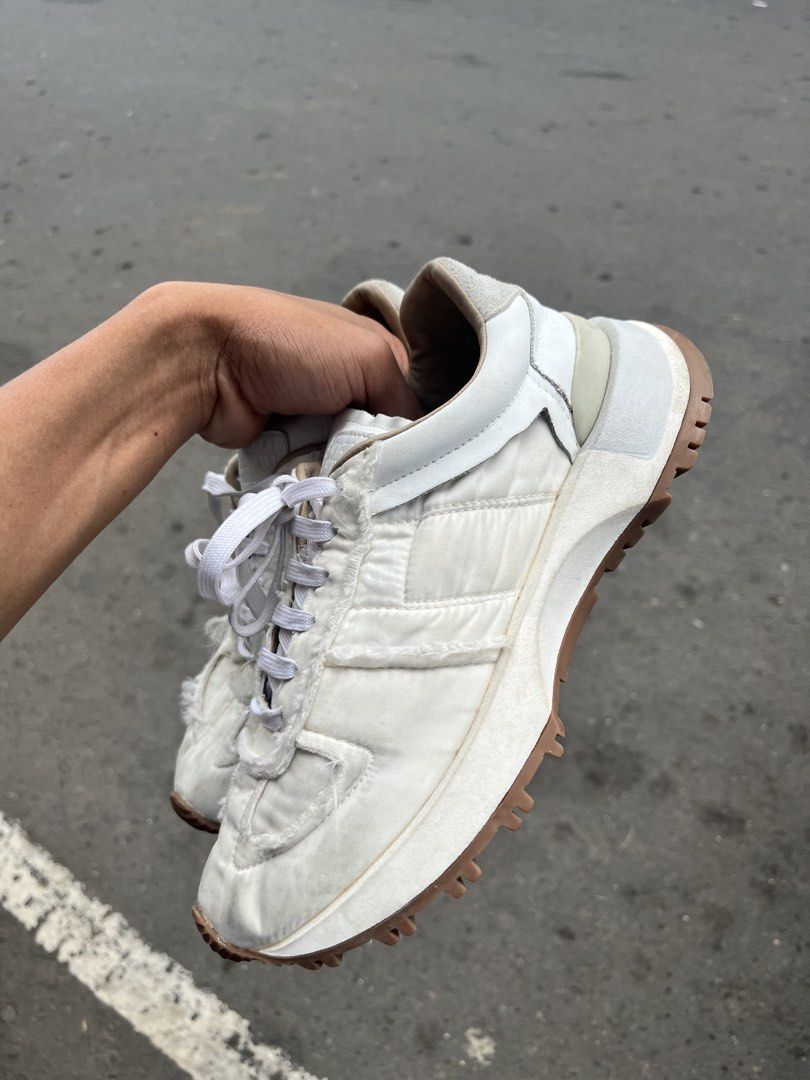 Maison Margiela Retro Runner White Sneakers (Category: Sneakers) located in Manila. Submitted by jj_thrift (Listing ID 1467949418, Image 1). Description: - Brand: Maison Margiela - Model: Retro Runner Sneakers - Color: White - Upper: Quilted nylon with raw frayed edges and leather accents - Sole: Heavy-traction gum rubber lug sole - Details: Branded tongue patch, embossed numeric branding at the heel wrap, white lace-up closure - Style: Clean aes