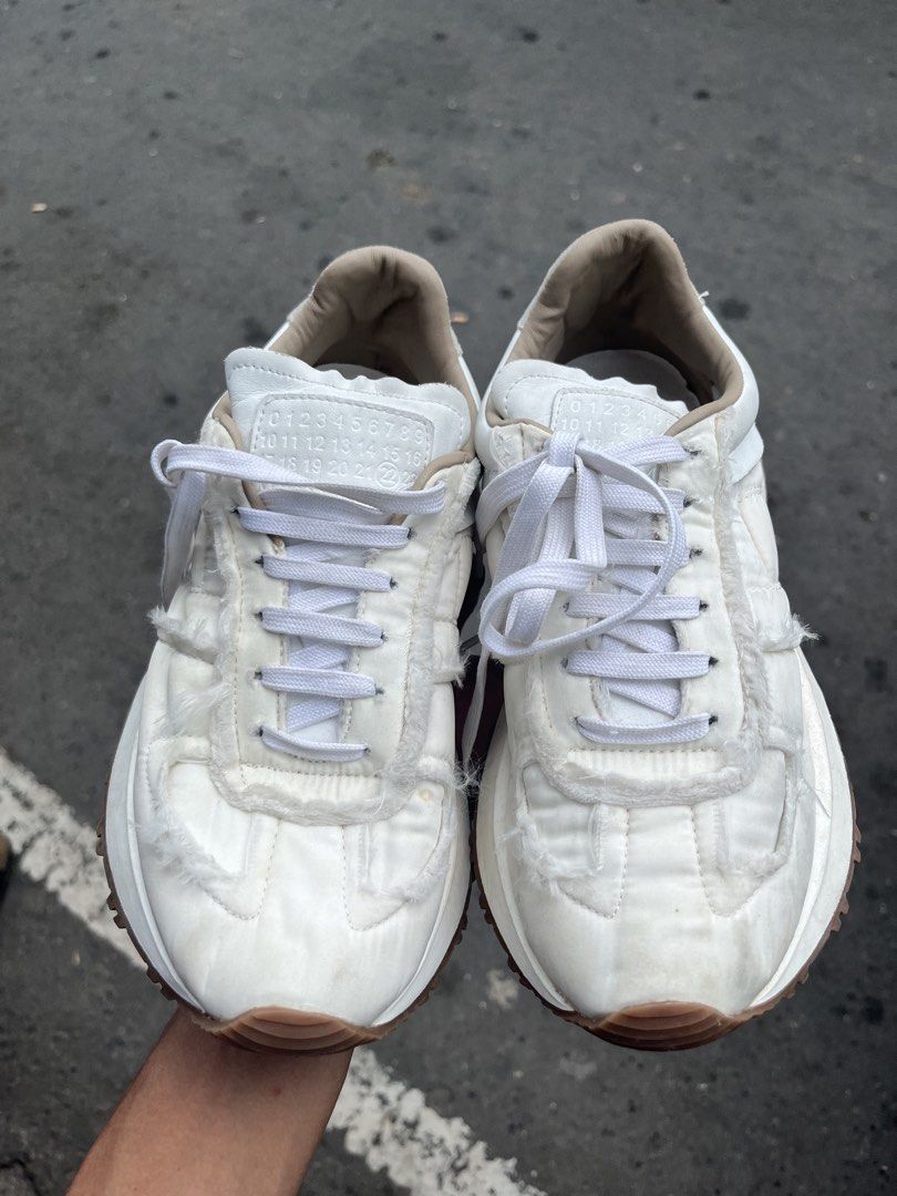 Maison Margiela Retro Runner White Sneakers (Category: Sneakers) located in Manila. Submitted by jj_thrift (Listing ID 1467949418, Image 2). Description: - Brand: Maison Margiela - Model: Retro Runner Sneakers - Color: White - Upper: Quilted nylon with raw frayed edges and leather accents - Sole: Heavy-traction gum rubber lug sole - Details: Branded tongue patch, embossed numeric branding at the heel wrap, white lace-up closure - Style: Clean aes