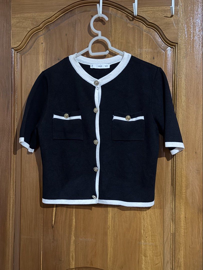 Mango Knit Cardigan (Category: Coats, Jackets and Outerwear) located in Caloocan City. Submitted by sisi_p (Listing ID 1467907672, Image 1). Description: - Style: Black knit cardigan with white trim and ornate gold-tone buttons - Details: Short sleeves, round neckline, front button closure, and two chest pockets with button flaps - Size: S bought this here on Carousell, but unfortunately, it doesn’t fit me. Selling it instead!.