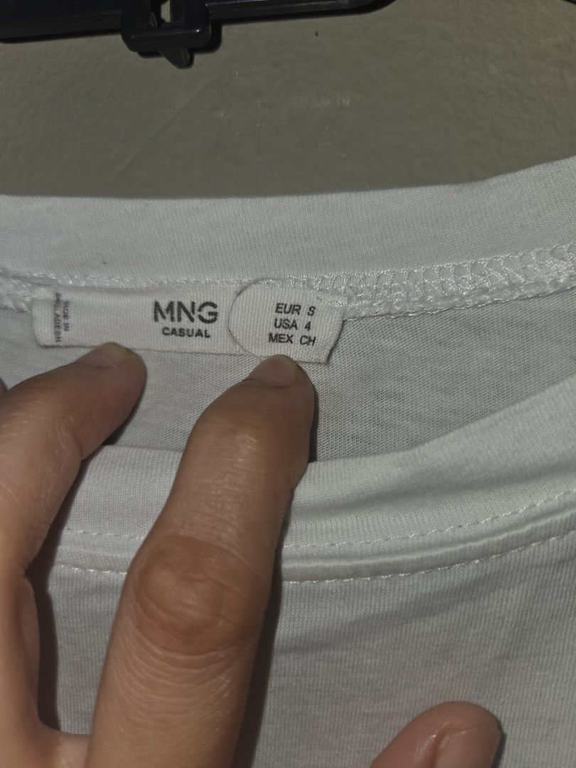 MANGO White Embroidered T-shirt (Category: Shirts) located in Quezon City. Submitted by klarebear15 (Listing ID 1468029000, Image 3). Description: - Brand: Mango - Color: White with black embroidered typography - Material: Soft, comfortable cotton - Design: Classic crew neck, short sleeves, plain solid back - Style: Casual everyday top, easy to pair with jeans or shorts.