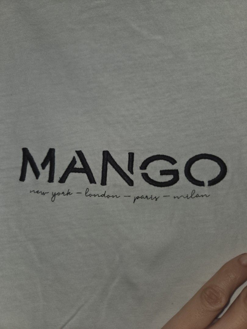 MANGO White Embroidered T-shirt (Category: Shirts) located in Quezon City. Submitted by klarebear15 (Listing ID 1468029000, Image 2). Description: - Brand: Mango - Color: White with black embroidered typography - Material: Soft, comfortable cotton - Design: Classic crew neck, short sleeves, plain solid back - Style: Casual everyday top, easy to pair with jeans or shorts.
