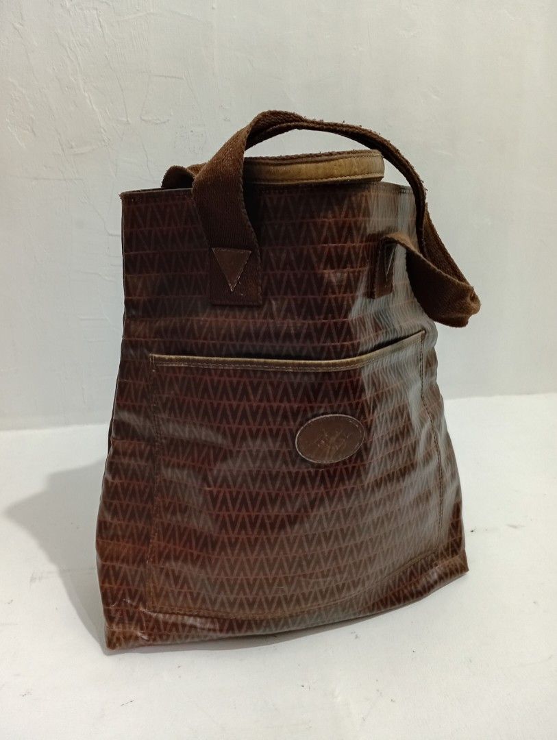Mario Valentino Monogram Brown Tote Bag (Category: Luxury Bags & Wallets) located in Manila. Submitted by eriiicaspage (Listing ID 1467882345, Image 2). Description: PreOwned Lightly Used Authentic Mario Valentino brown tote bag with classic repeating V monogram pattern - Made in Italy with structured shape that holds up very well - Features comfortable double fabric shoulder straps with minor wear - Convenient exterior slip pocket for quick acce