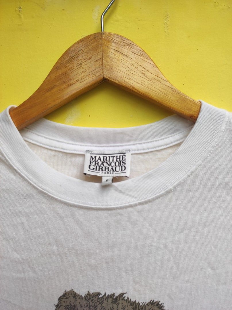 Marithe Francois Girbaud White Bear T-shirt Size S (Category: Shirts) located in Cuartero. Submitted by tripthriftfinds (Listing ID 1467879613, Image 2). Description: - Brand: Marithe Francois Girbaud (Paris brand) - Color: Classic White - Size: S (tag at collar) - Design: Front graphic of a teddy bear wearing a branded top - Details: Short sleeves, crew neckline, care label inside - Condition: Pre-loved, well-maintained - Style: Casual, easy to 