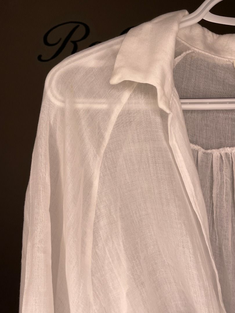 Maronie White Tie-Front Lightweight Blouse Size M (Category: Blouses) located in Taguig. Submitted by re.wear.mnl (Listing ID 1468007070, Image 3). Description: - Brand: Maronie - Size: M - Color: White - Style: Tie-front blouse with collar and 3/4 sleeves - Fabric: Lightweight and semi-sheer - Versatile: Great for casual wear or as a swimwear cover-up/layering piece - Flaw: Small yellow stain near the front tie knot (see last photo for reference
