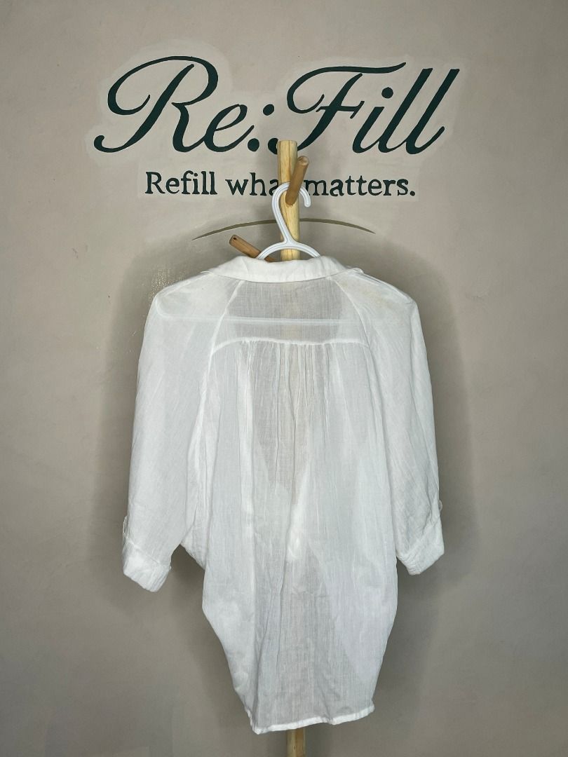 Maronie White Tie-Front Lightweight Blouse Size M (Category: Blouses) located in Taguig. Submitted by re.wear.mnl (Listing ID 1468007070, Image 2). Description: - Brand: Maronie - Size: M - Color: White - Style: Tie-front blouse with collar and 3/4 sleeves - Fabric: Lightweight and semi-sheer - Versatile: Great for casual wear or as a swimwear cover-up/layering piece - Flaw: Small yellow stain near the front tie knot (see last photo for reference