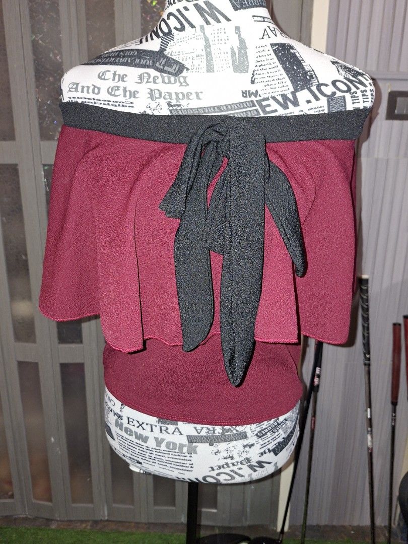 Maroon Peplum Top with Black Bow and Trim (Category: Sleeveless) located in Manila. Submitted by mialiurshop (Listing ID 1467903277, Image 2). Description: - Color: Deep maroon with bold black trim - Design: Layered peplum with flared sleeves and a front bow - Texture: Textured fabric all over - Style: Versatile for casual or dressed-up outfits - Condition: Great piece, ready to wear - dark maroon in actual .