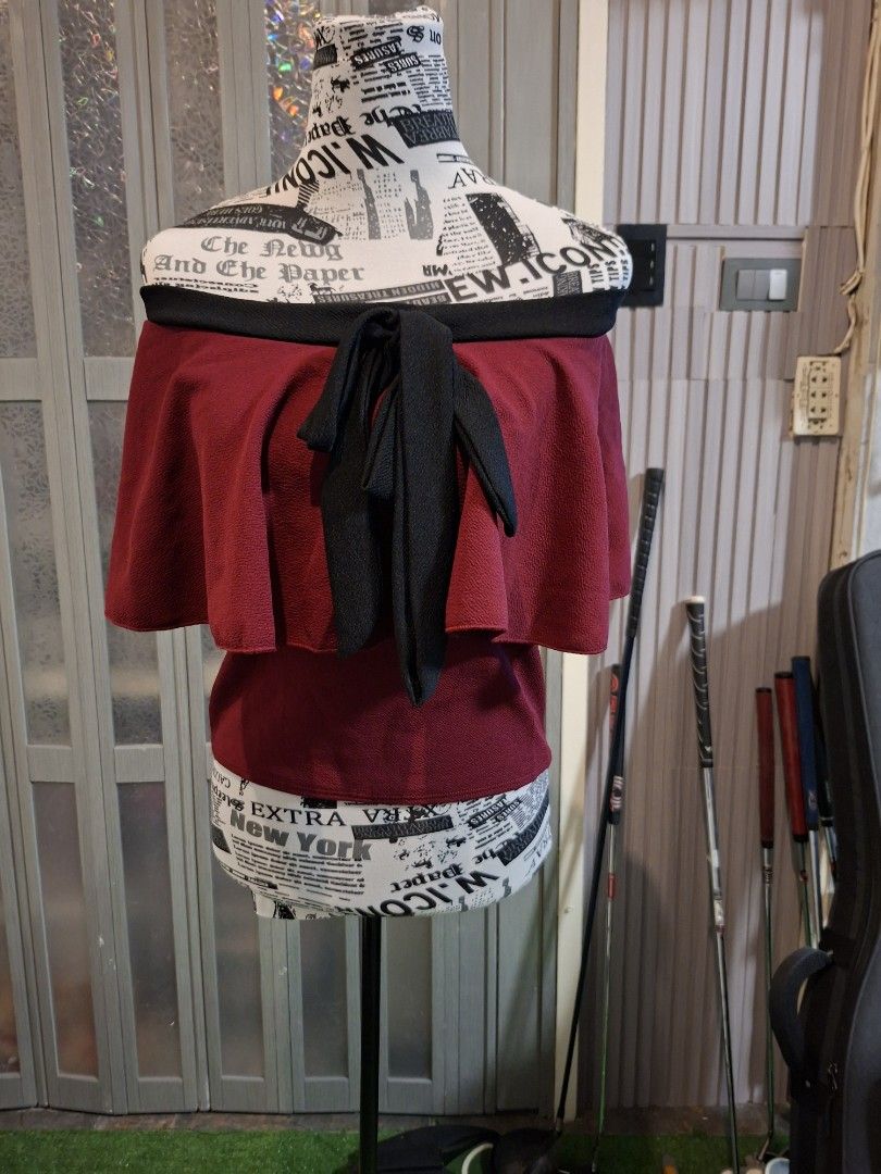 Maroon Peplum Top with Black Bow and Trim (Category: Sleeveless) located in Manila. Submitted by mialiurshop (Listing ID 1467903277, Image 1). Description: - Color: Deep maroon with bold black trim - Design: Layered peplum with flared sleeves and a front bow - Texture: Textured fabric all over - Style: Versatile for casual or dressed-up outfits - Condition: Great piece, ready to wear - dark maroon in actual .