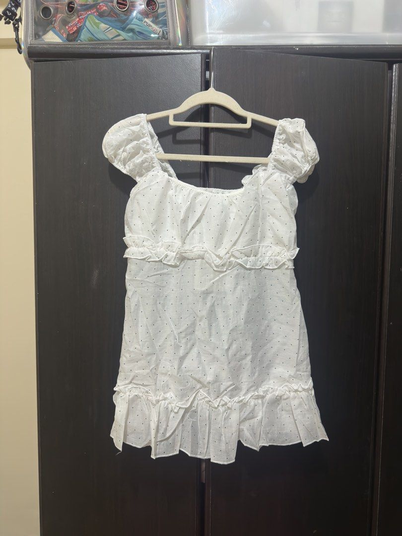 Marry House White Polka Dot Ruffle Top (Category: Blouses) located in Villasis. Submitted by juliaxgamboa (Listing ID 1467945853, Image 2). Description: - Bangkok top - Condition: Brand New with Tag (BNWT), never worn - Design: White mini dress with all-over black polka dots and tiered ruffles - Details: Square neckline, chic puff sleeves - Fit: Comfortable smocked bodice and waistline - Fabric: Lightweight and breathable - Origin: Made in Thaila