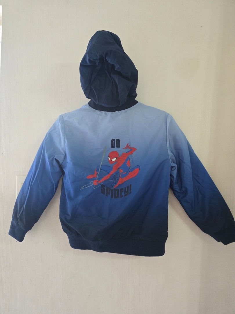 Marvel Spiderman Hooded Thick Jacket 7Y (Category: Babies & Kids Fashion) located in Las Pinas. Submitted by garieh (Listing ID 1467910163, Image 2). Description: Spider-Man jacket from C&A. Blue ombre design with zipper front and attached hood. Small Spidey patch on the chest and large "GO SPIDEY!" graphic printed on the back. Two front pockets. Inside label shows size 122cm, fits around 7 years old. Dark blue lining inside. Great outerwear piec