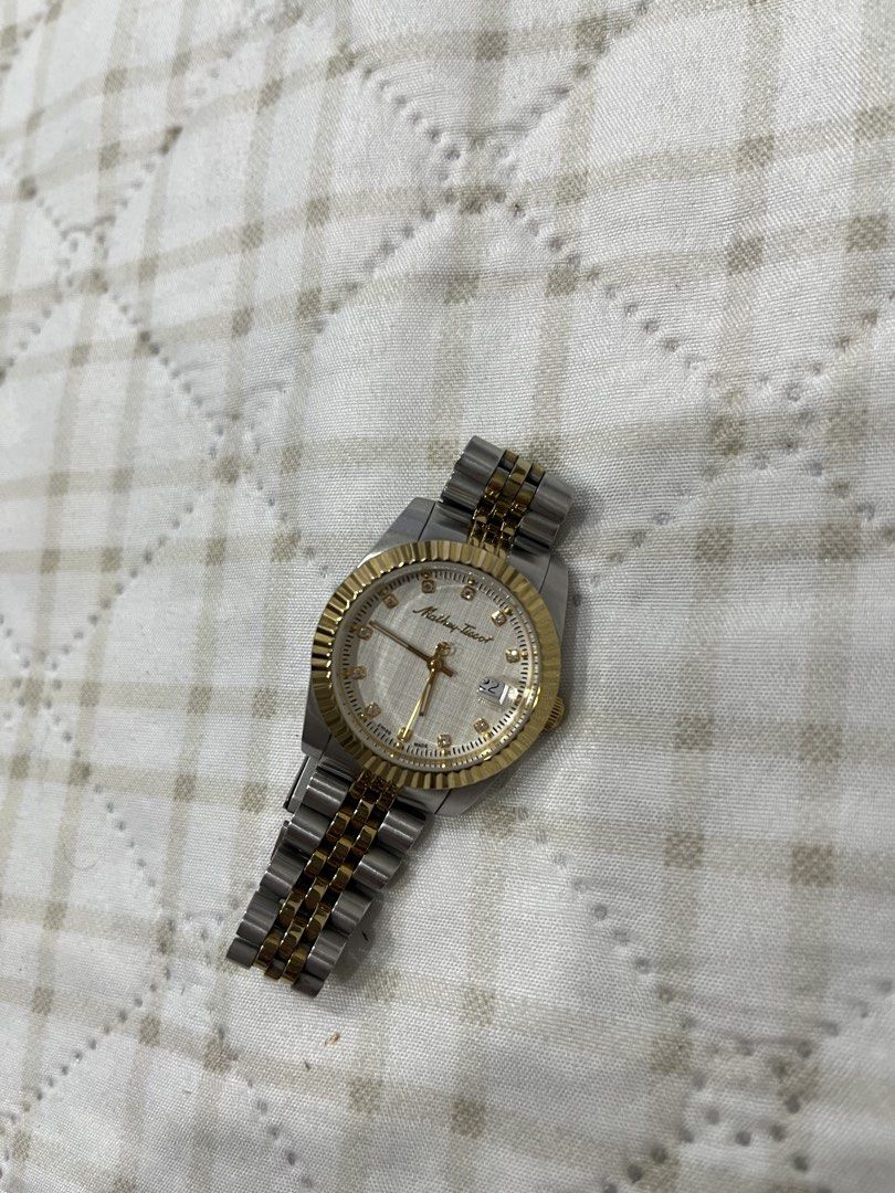 Mathey-Tissot Two-Tone Diamond Dial Watch (Category: Women's Watches) located in Bulacan. Submitted by lovebyc. (Listing ID 1467905236, Image 1). Description: - Brand: Mathey-Tissot - Design: Two-tone silver and gold stainless steel - Dial: Textured white with sparkling stone hour markers - Bezel: Fluted gold-tone bezel - Features: Date window at 3 o'clock position and logo-detailed crown - Bracelet: Jubilee-style band with secure clasp closure -