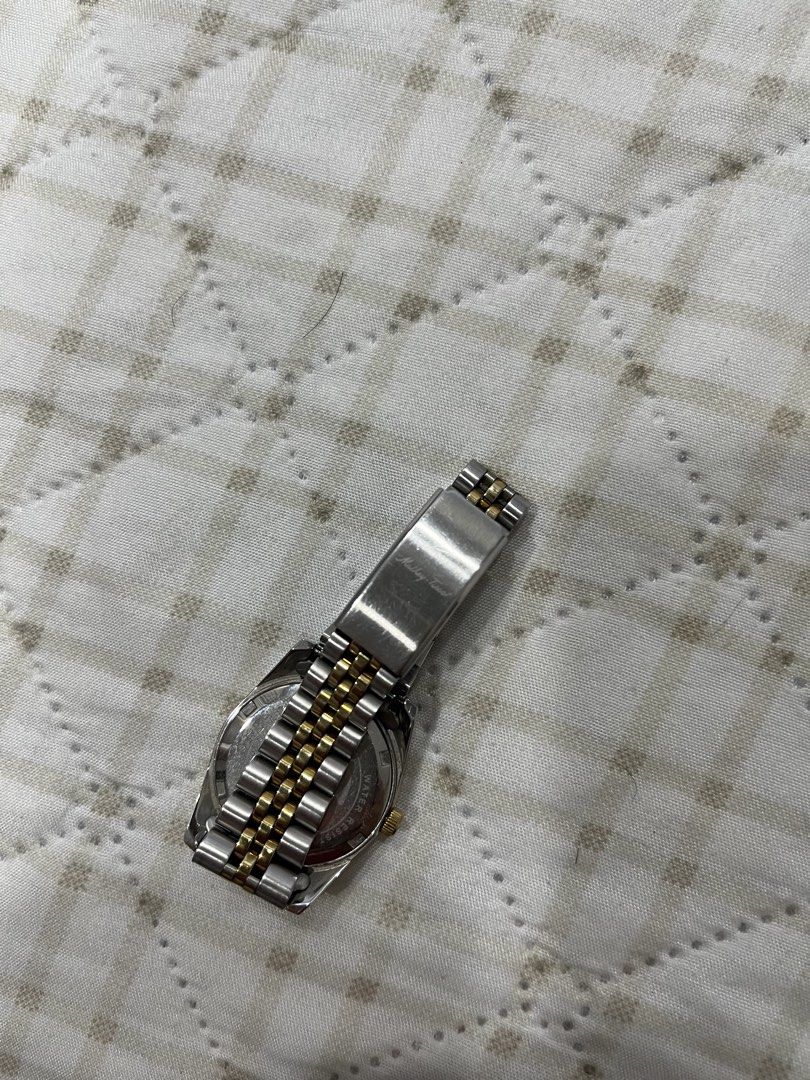 Mathey-Tissot Two-Tone Diamond Dial Watch (Category: Women's Watches) located in Bulacan. Submitted by lovebyc. (Listing ID 1467905236, Image 2). Description: - Brand: Mathey-Tissot - Design: Two-tone silver and gold stainless steel - Dial: Textured white with sparkling stone hour markers - Bezel: Fluted gold-tone bezel - Features: Date window at 3 o'clock position and logo-detailed crown - Bracelet: Jubilee-style band with secure clasp closure -