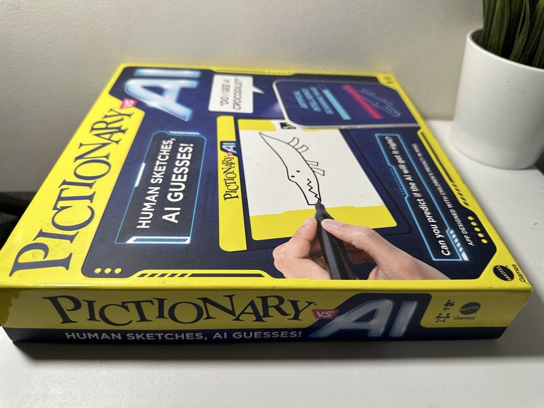 Mattel Pictionary vs AI Game (Category: Board Games & Puzzles) located in Cabanatuan. Submitted by s.kit.27 (Listing ID 1468019794, Image 2). Description: - Game: Pictionary vs AI by Mattel - Players & Age: 2 to 4 players, ages 8 and up - How to play: Humans sketch drawings and AI tries to guess them - Inclusions: Phone holder, erasable board holder, gameboard, 112 clue cards, 4 movers, 4 wet erase markers, 4 erasable boards, and 8 tokens - Condi