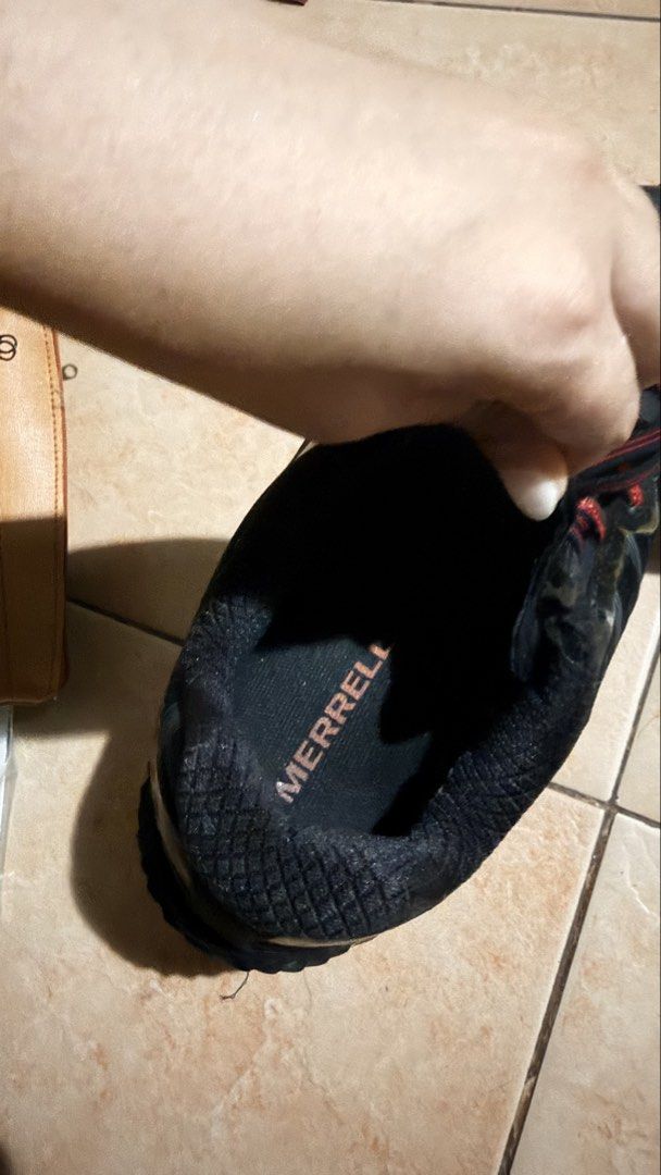 Merrell Trail Running Shoes Black Red (Category: Sneakers) located in Cebu City. Submitted by eynjlin (Listing ID 1468010621, Image 2). Description: - Brand/Model: Merrell Trail Running Shoes - Color: Black and Red - Closure: Lace-up - Upper: Breathable mesh - Sole: Heavy-duty grip with durable red lugs and plenty of tread left - Condition: Heavily used with visible wear and tear around the toe caps/edges, plus some adhesive residue from minor re