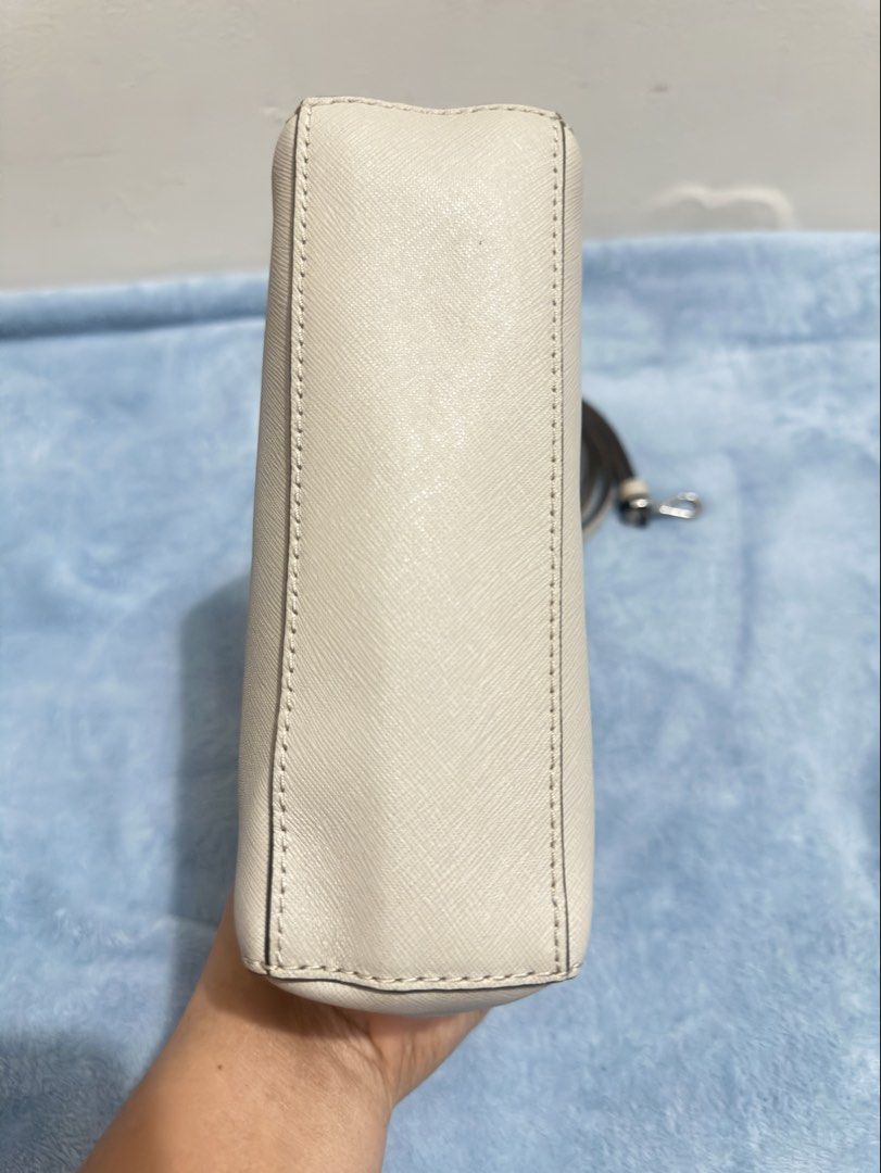 Michael Kors Ava Mini Crossbody Bag (Category: Cross-body Bags) located in Calamba. Submitted by nympha0630 (Listing ID 1467875173, Image 2). Description: - Brand: Michael Kors - Material: Durable Saffiano leather in versatile off-white - Hardware: Silver-tone with chic front flap turnlock charm - Exterior: Structured rectangular shape with flat base and back slip pocket - Interior: Fabric-lined with 1 zipper pocket and 1 slip pocket - Strap: Com