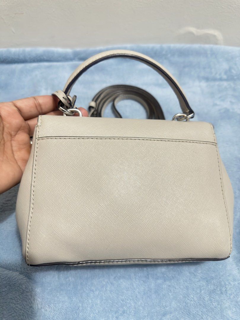 Michael Kors Ava Mini Crossbody Bag (Category: Cross-body Bags) located in Calamba. Submitted by nympha0630 (Listing ID 1467875173, Image 3). Description: - Brand: Michael Kors - Material: Durable Saffiano leather in versatile off-white - Hardware: Silver-tone with chic front flap turnlock charm - Exterior: Structured rectangular shape with flat base and back slip pocket - Interior: Fabric-lined with 1 zipper pocket and 1 slip pocket - Strap: Com