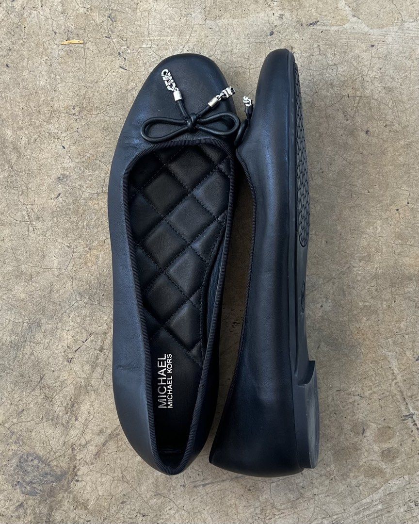 Michael Kors Black Quilted Ballet Flats with Bow (Category: Flats & Sandals) located in Malita. Submitted by happy_duckling (Listing ID 1467846534, Image 2). Description: - Brand: Michael Kors - Style: Black leather ballet flats with round toe and slip-on design - Details: Cute front bow tie with silver-tone MK charms and quilted diamond inner sole - Condition: Clean black leather upper with light scuffing on the soles from normal walking - Perfe