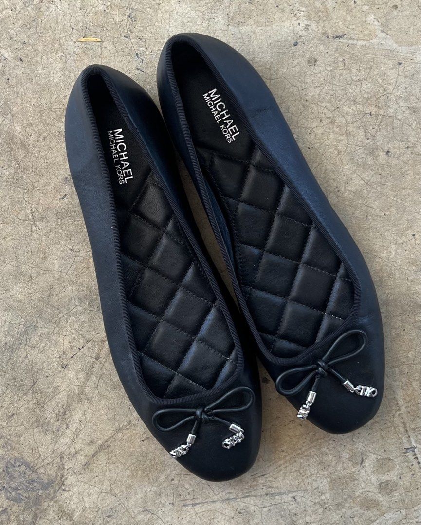 Michael Kors Black Quilted Ballet Flats with Bow (Category: Flats & Sandals) located in Malita. Submitted by happy_duckling (Listing ID 1467846534, Image 3). Description: - Brand: Michael Kors - Style: Black leather ballet flats with round toe and slip-on design - Details: Cute front bow tie with silver-tone MK charms and quilted diamond inner sole - Condition: Clean black leather upper with light scuffing on the soles from normal walking - Perfe