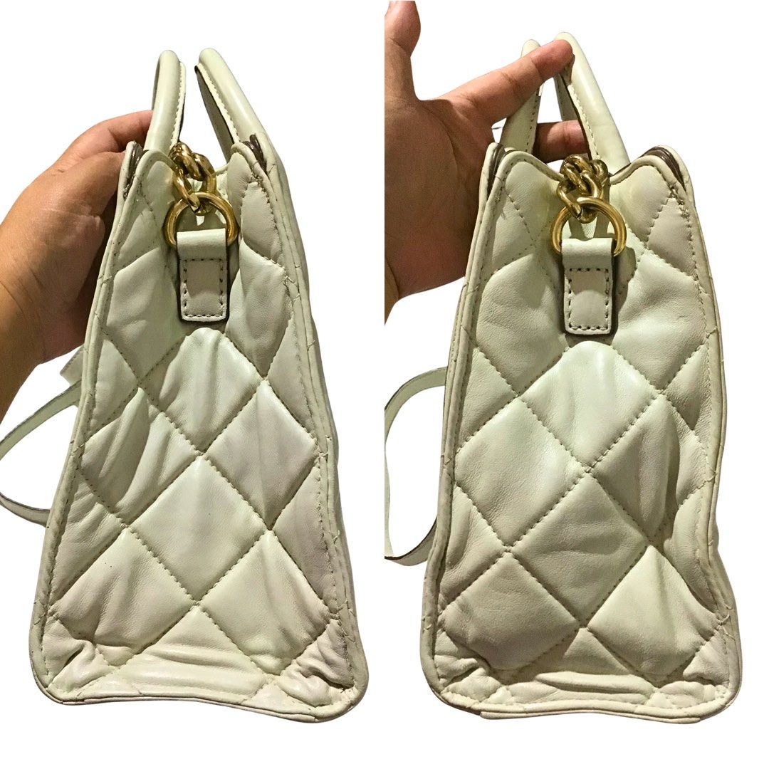 Michael Kors Hamilton Quilted Leather Tote - Off-white (Category: Luxury Bags & Wallets) located in Sorsogon. Submitted by sprucemuse (Listing ID 1467937280, Image 3). Description: Brand: Michael Kors Color: Off-white Type: Hand and Crossbody Bag Size: 33cm x 14cm x 24cm (Med-Large) Material: Genuine leather (outer), Textile (inner) Hardware: Gold Features: 1 zippered inner middle pocket, 1 zippered inner pocket, 4 open inner pockets, non-removab