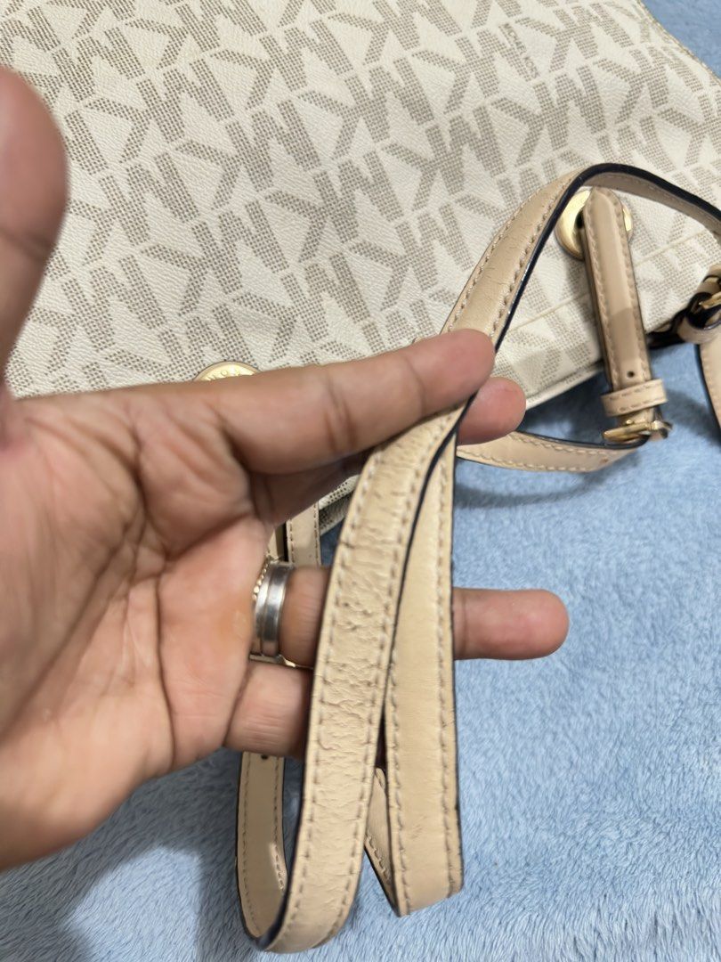 Michael Kors MK monogram canvas beige tote bag (Category: Luxury Bags & Wallets) located in Calamba. Submitted by nympha0630 (Listing ID 1467854260, Image 3). Description: - Brand: Michael Kors - Design: Classic beige & white MK monogram print with cream leather trim - Hardware: Premium gold-tone hardware - Straps: Dual shoulder straps with adjustable buckle details - Inclusion: Matching round MK logo charm - Interior: Spacious compartment, perfe
