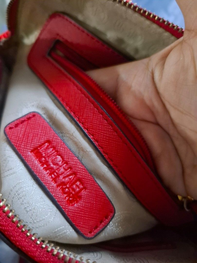 Michael Kors Red Dome Crossbody Bag (Category: Cross-body Bags) located in Marikina City. Submitted by bags21.ph (Listing ID 1467840283, Image 3). Description: - Brand: Michael Kors - Material: Textured Saffiano leather in bright red - Hardware: Gold-tone with front metal logo lettering - Strap: Adjustable with a stylish chain-link section - Closure & Interior: Zip top closure, fabric logo lining, slip pocket, and zipper pocket - Condition: Good 