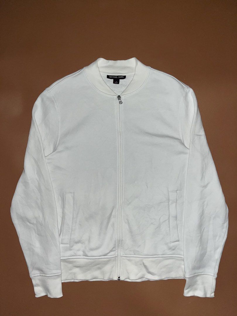 Michael Kors White Zip-up Bomber Jacket (Category: Coats, Jackets and Outerwear) located in Manila. Submitted by ykarevalo75660 (Listing ID 1467951489, Image 1). Description: Michael Kors zip-up jacket in crisp white. Ribbed collar, cuffs, and hem. Two front welt pockets. Silver-tone zipper with branded hardware. Size medium tag attached inside the neck. Cotton-blend fleece interior. Clean, minimalist look for everyday casual wear..