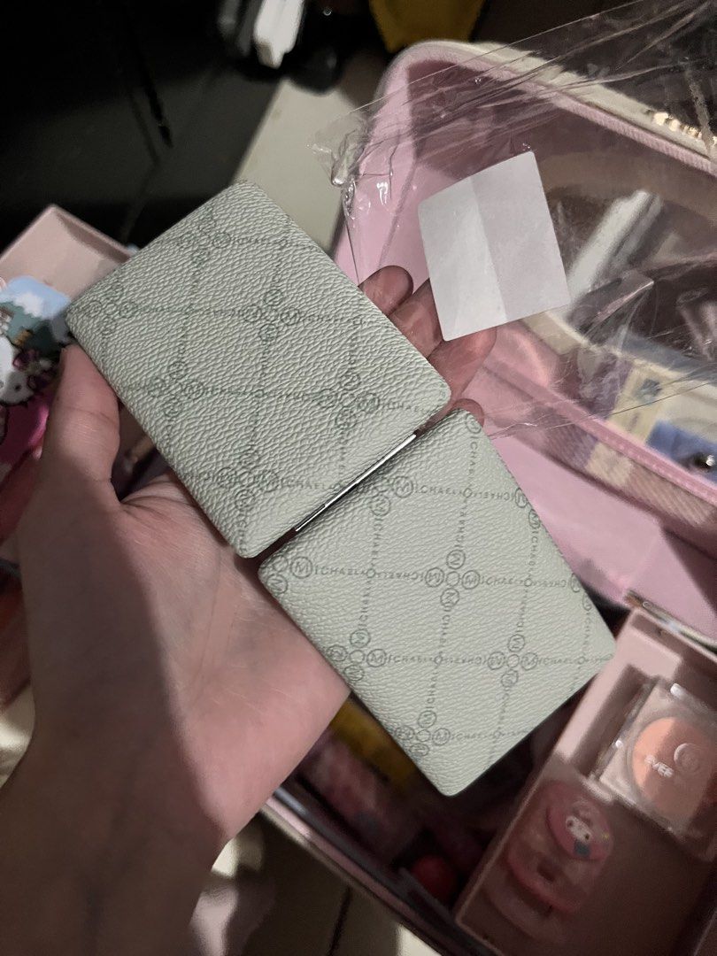 Michaela Monogram Compact Mirror (Category: Mirrors) located in Manila. Submitted by leiluvsu (Listing ID 1467948097, Image 1). Description: BNEW MICHALEA MIRROR WITH ORIGINAL PACKAGING - Stylish monogram print pattern - Dual mirrors inside for easy touch-ups - Compact size fits easily in any handbag or makeup pouch 👛 mop : gcash | maya | bpi 📦 mod : jnt | lbc 📍 loc : mendiola / cavite .