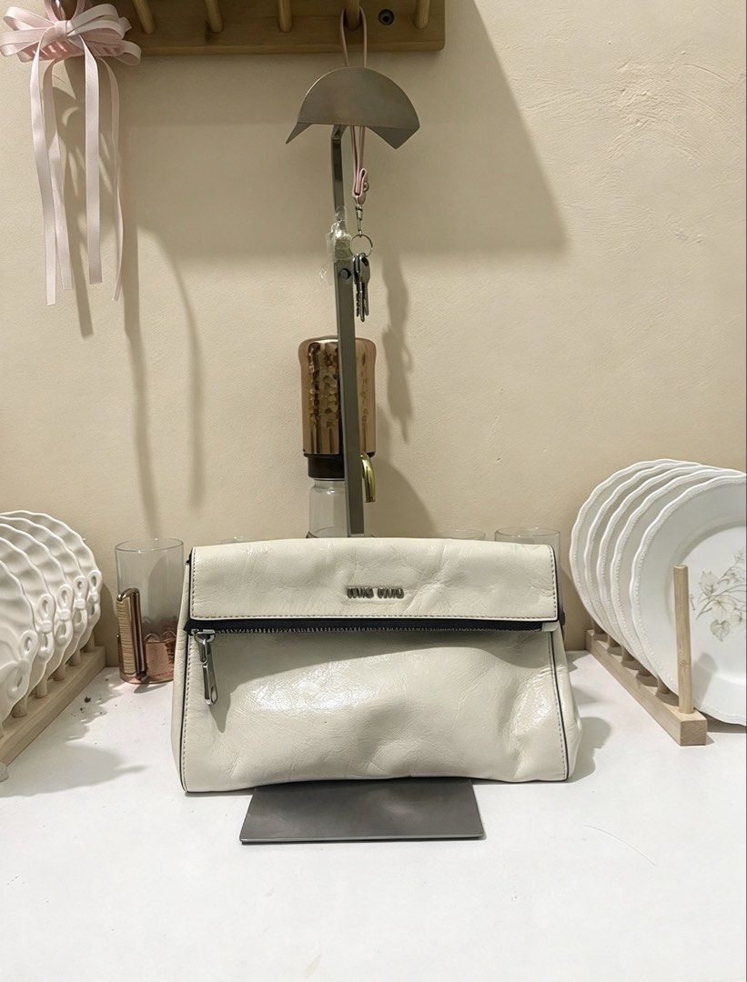 Miu Miu Calfskin Clutch (Category: Belt bags, Clutches and Pouches) located in Manila. Submitted by thriftniyuno (Listing ID 1467997321, Image 1). Description: Color transfer back part but still good condition .