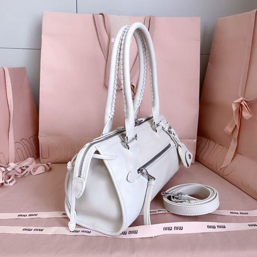 Miu Miu White Leather Bag (Category: Luxury Bags & Wallets) located in Las Pinas. Submitted by odehyeszum11031 (Listing ID 1467926103, Image 2). Description: - Brand: Miu Miu - Material: Premium white leather - Hardware: Silver-tone - Features: Front zip pocket, debossed logo lettering - Straps: Top handles and a detachable, adjustable shoulder strap - Condition: Excellent, clean finish.