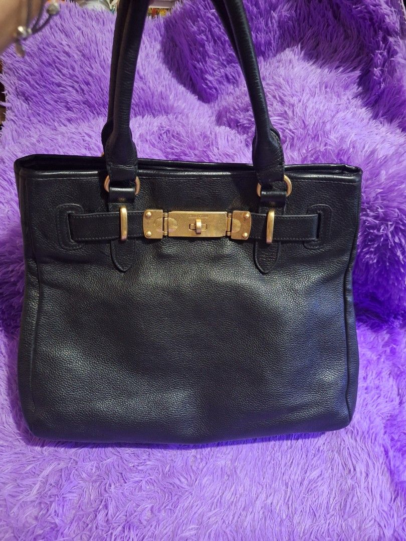 MiuMiu Vintage Tote Black (Category: Luxury Bags & Wallets) located in Quezon City. Submitted by cloudymay (Listing ID 1465886355, Image 3). Description: Genuine Leather Gold Hardwares Issue: minimal rubber lining missing see last photo. Vintage style, no white tag.