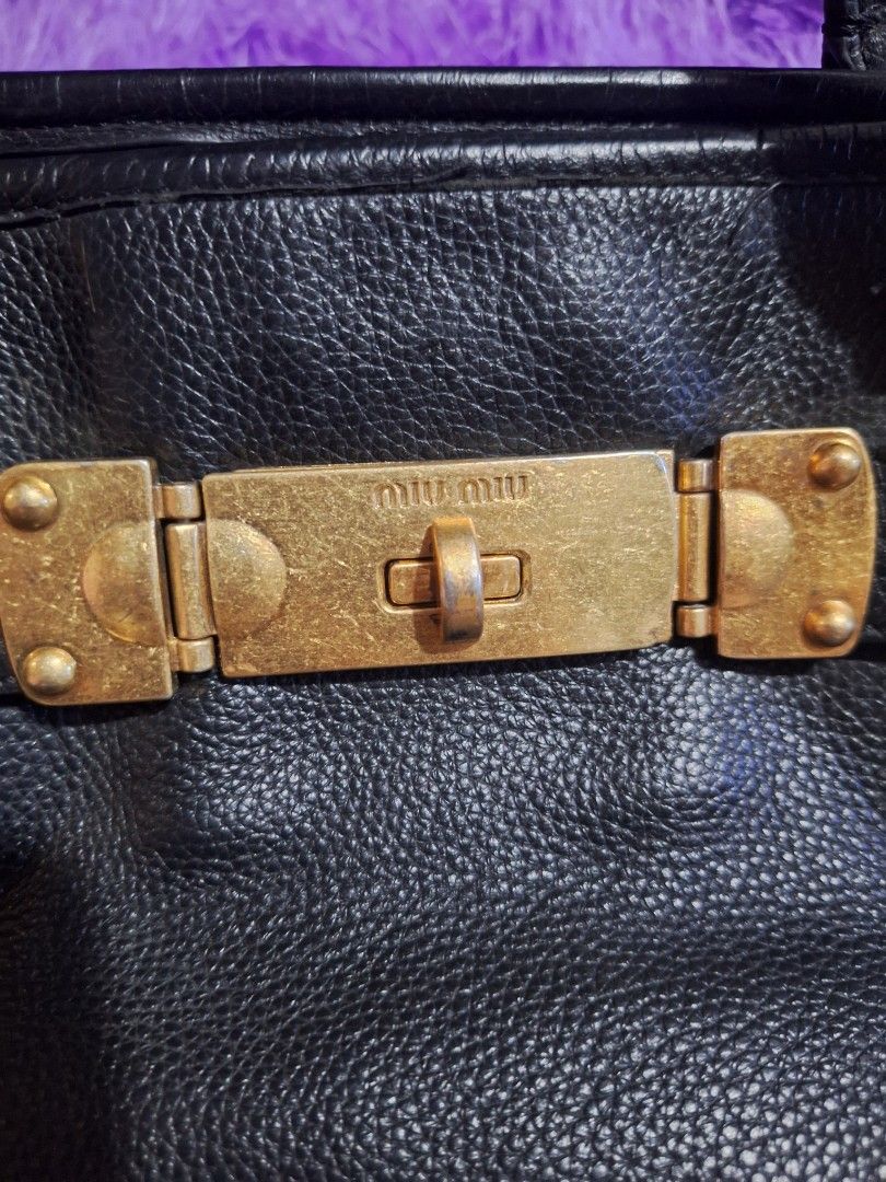 MiuMiu Vintage Tote Black (Category: Luxury Bags & Wallets) located in Quezon City. Submitted by cloudymay (Listing ID 1465886355, Image 1). Description: Genuine Leather Gold Hardwares Issue: minimal rubber lining missing see last photo. Vintage style, no white tag.