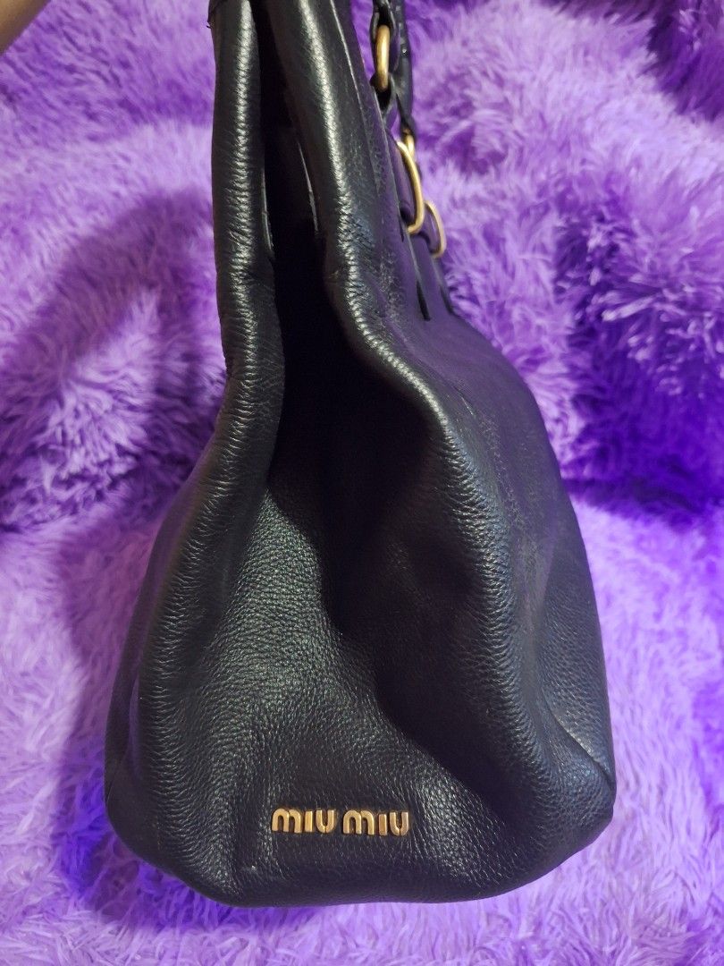 MiuMiu Vintage Tote Black (Category: Luxury Bags & Wallets) located in Quezon City. Submitted by cloudymay (Listing ID 1465886355, Image 2). Description: Genuine Leather Gold Hardwares Issue: minimal rubber lining missing see last photo. Vintage style, no white tag.