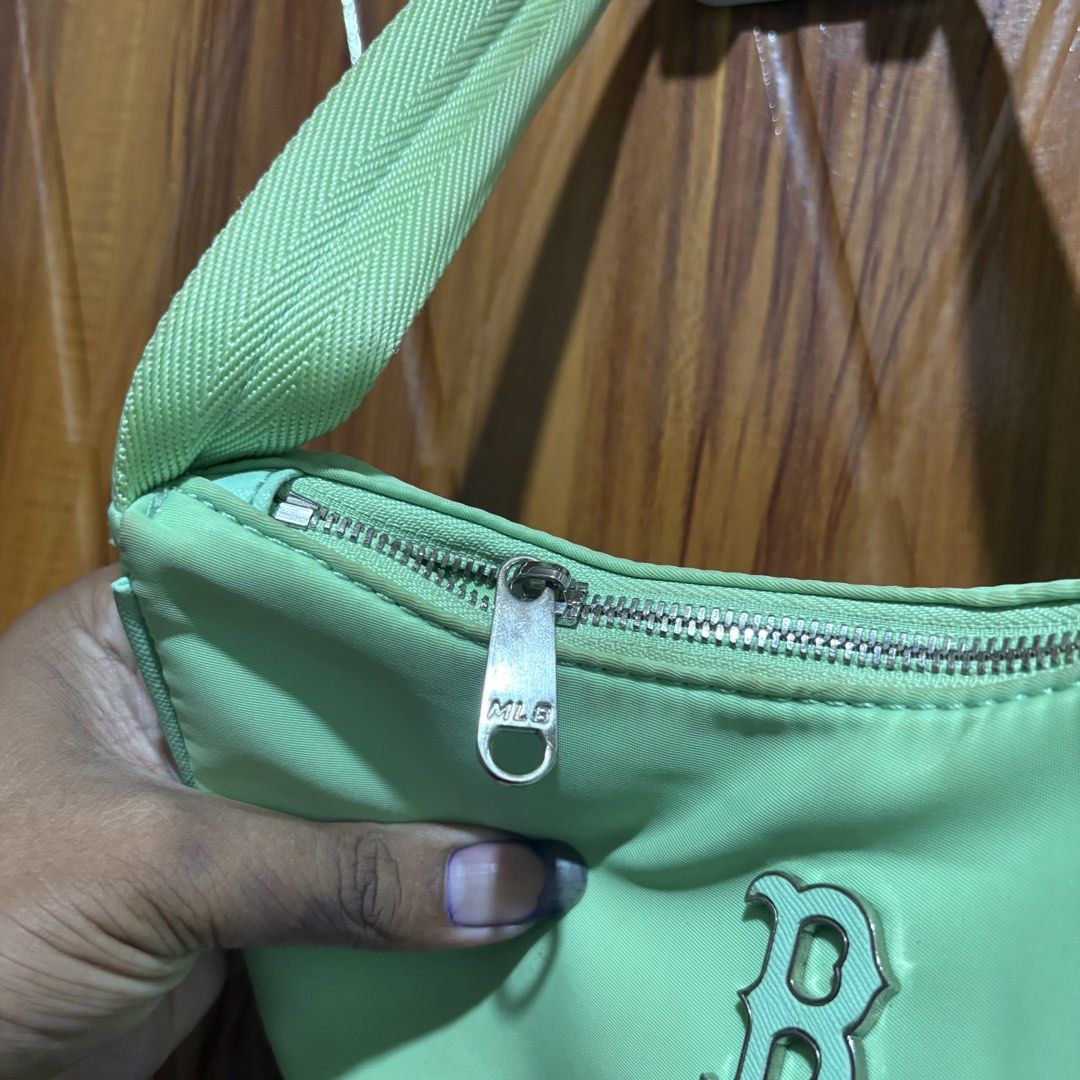 MLB Boston Red Sox Nylon Shoulder Bag Green (Category: Shoulder Bags) located in Carmen. Submitted by rr_thrifts (Listing ID 1467931647, Image 3). Description: - MLB Boston Red Sox shoulder bag - Color: Pastel green - Material: Durable nylon with silver-tone hardware - Closure: Secure zip closure - Details: Iconic 'B' logo on the front, interior label and tag attached - Size: Handy and spacious enough for daily essentials - Condition: Clean strap
