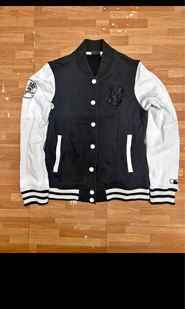 MLB New York Yankees Varsity Jacket Black White (Category: Coats, Jackets and Outerwear) located in Manila. Submitted by applemint011 (Listing ID 1467875270, Image 1). Description: - Brand: MLB New York Yankees - Item: Varsity Jacket - Color: Black body with white sleeves - Size: L - Closure: Snap-button front - Details: Crystal-embellished NY logo on chest, baseball patch on right sleeve, and MLB batterman logo embroidery on left cuff - Features