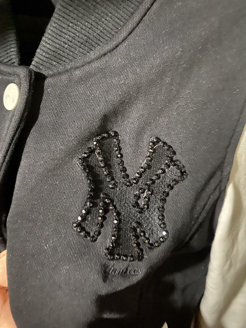 MLB New York Yankees Varsity Jacket Black White (Category: Coats, Jackets and Outerwear) located in Manila. Submitted by applemint011 (Listing ID 1467875270, Image 3). Description: - Brand: MLB New York Yankees - Item: Varsity Jacket - Color: Black body with white sleeves - Size: L - Closure: Snap-button front - Details: Crystal-embellished NY logo on chest, baseball patch on right sleeve, and MLB batterman logo embroidery on left cuff - Features
